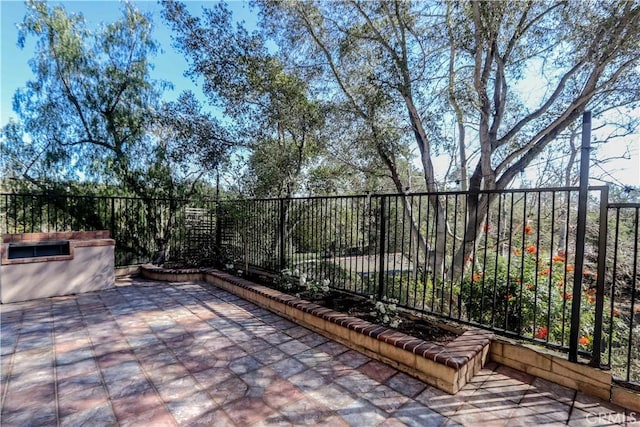 view of patio / terrace featuring fence