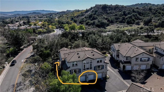 birds eye view of property with a mountain view