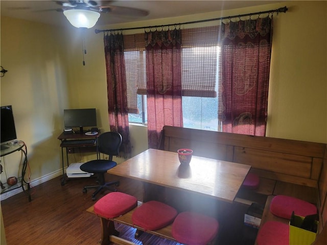 dining room featuring wood finished floors, a ceiling fan, and baseboards