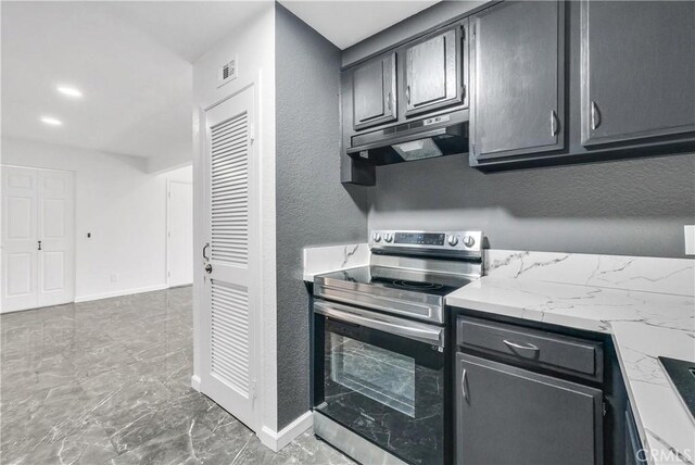 22809 Hilton Head Dr Unit 14, Diamond Bar, CA 91765 - kitchen featuring electric range, under cabinet range hood, baseboards, marble finish floors, and a textured wall