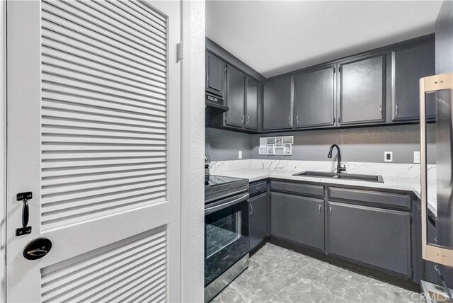 22809 Hilton Head Dr Unit 14, Diamond Bar, CA 91765 - kitchen with stainless steel electric stove, a sink, gray cabinetry, light stone counters, and extractor fan
