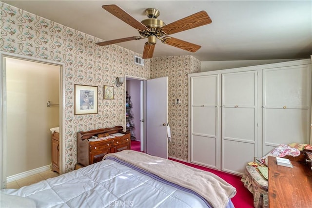 bedroom with wallpapered walls, light tile patterned floors, ceiling fan, and lofted ceiling
