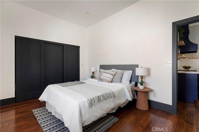 bedroom featuring baseboards and dark wood finished floors