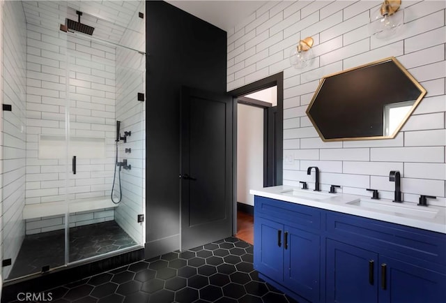 bathroom with a sink, a shower stall, and tile patterned floors