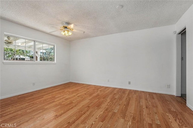 unfurnished room featuring light wood finished floors, a textured ceiling, baseboards, and a ceiling fan