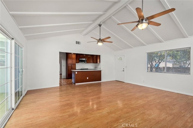 unfurnished living room featuring baseboards, visible vents, beamed ceiling, light wood-type flooring, and high vaulted ceiling