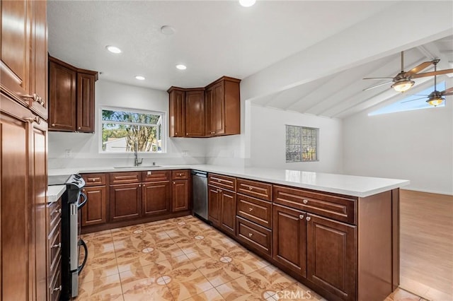 kitchen with lofted ceiling with beams, a peninsula, stainless steel appliances, a sink, and light countertops