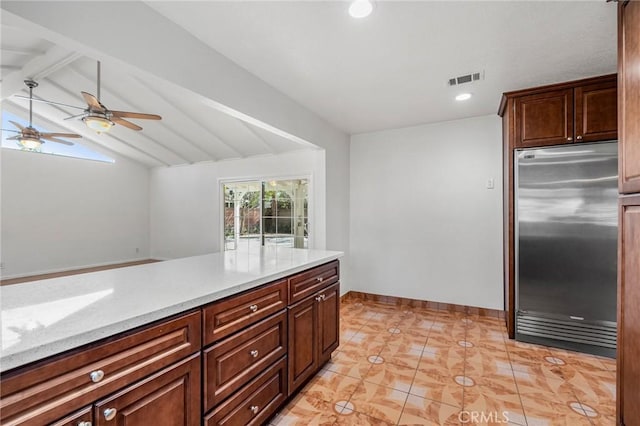 kitchen with recessed lighting, visible vents, lofted ceiling with beams, stainless steel built in fridge, and baseboards