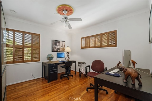 office with baseboards, a ceiling fan, wood finished floors, and ornamental molding