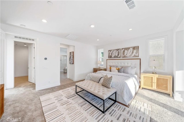 bedroom featuring baseboards, recessed lighting, visible vents, and light colored carpet