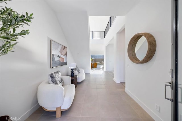 hall with light tile patterned floors and baseboards