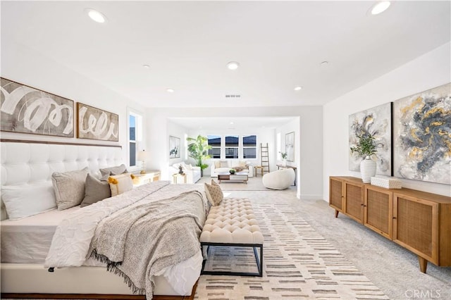 bedroom featuring light carpet, visible vents, and recessed lighting