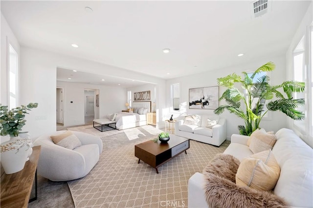 living room with light colored carpet, recessed lighting, and visible vents