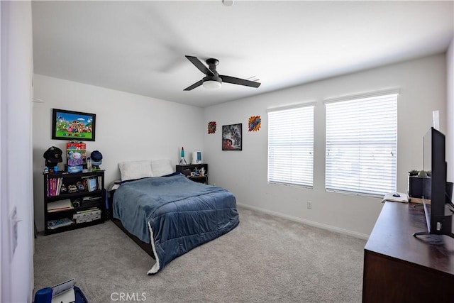 bedroom with a ceiling fan, light colored carpet, and baseboards