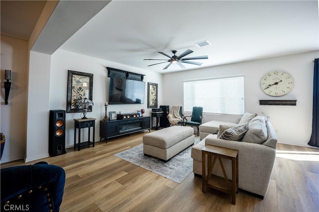 living room with visible vents, ceiling fan, and wood finished floors