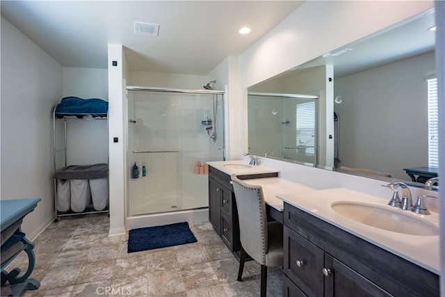 bathroom featuring a shower stall, visible vents, and a sink