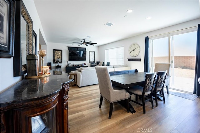 dining area featuring light wood-style floors, recessed lighting, visible vents, and a ceiling fan