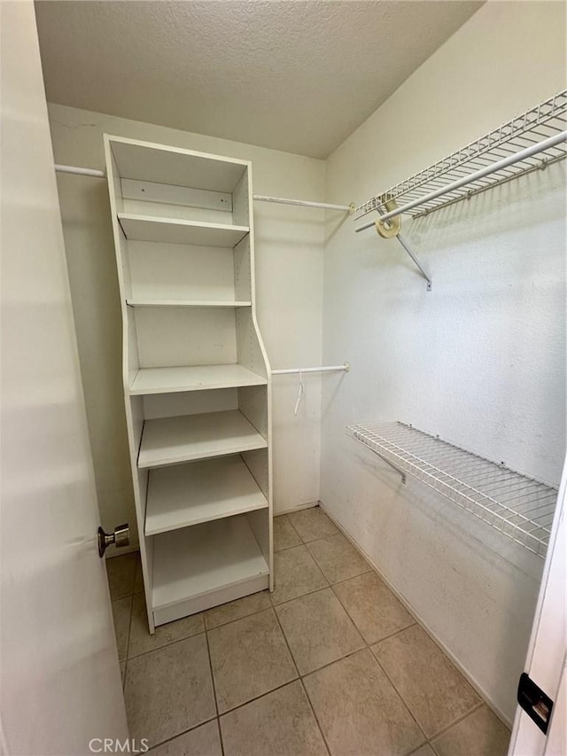 walk in closet featuring light tile patterned floors