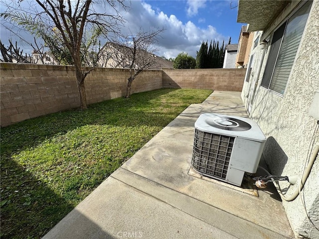 view of yard featuring a patio area, a fenced backyard, and cooling unit