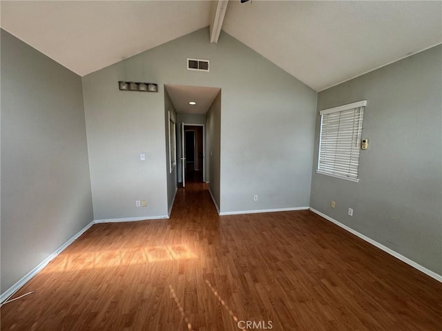 spare room featuring dark wood-style floors, visible vents, high vaulted ceiling, beamed ceiling, and baseboards