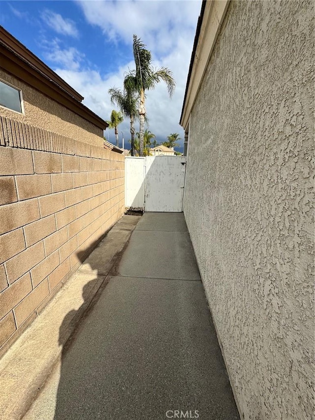 view of side of property featuring fence and stucco siding