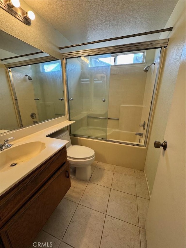 full bath featuring toilet, combined bath / shower with glass door, a textured ceiling, vanity, and tile patterned floors