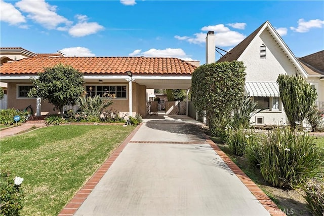 view of front facade featuring a chimney, stucco siding, concrete driveway, a front yard, and an attached carport