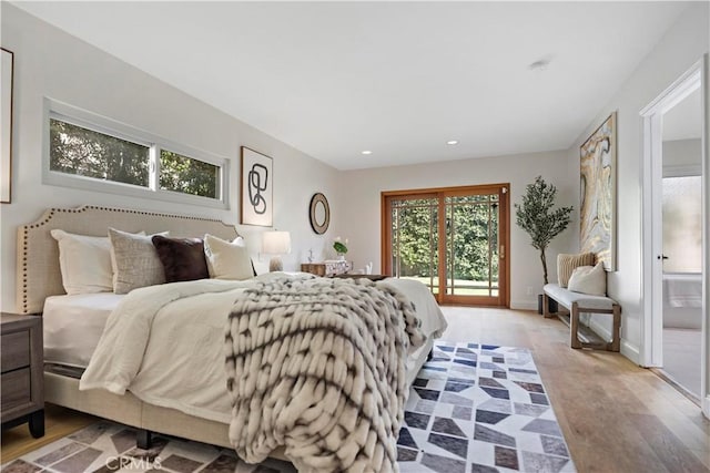 bedroom featuring baseboards, light wood finished floors, recessed lighting, and access to exterior