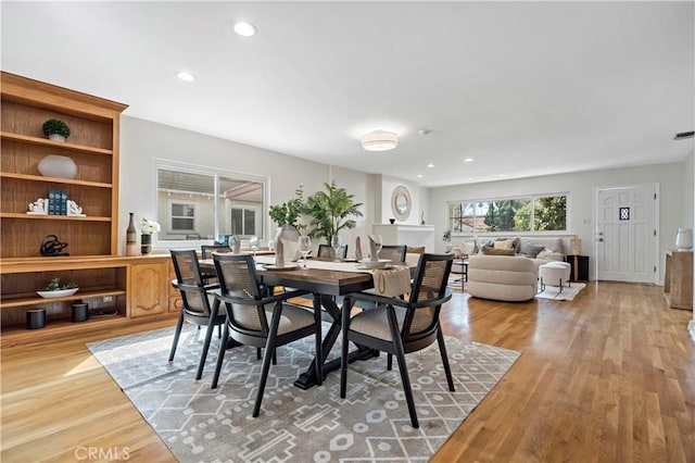 dining area featuring light wood-type flooring and recessed lighting