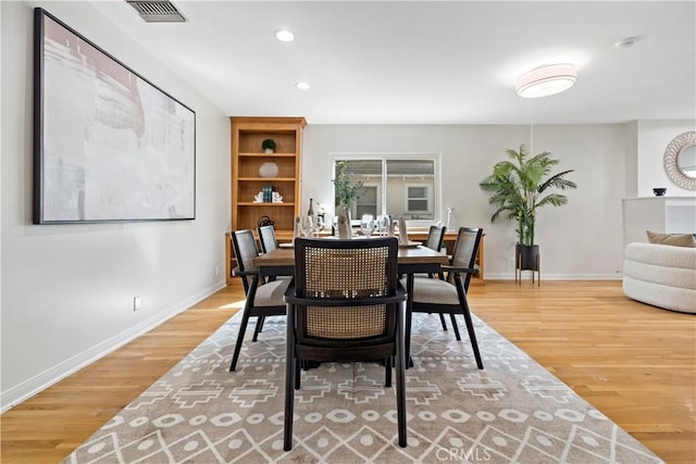 dining room with recessed lighting, wood finished floors, visible vents, and baseboards