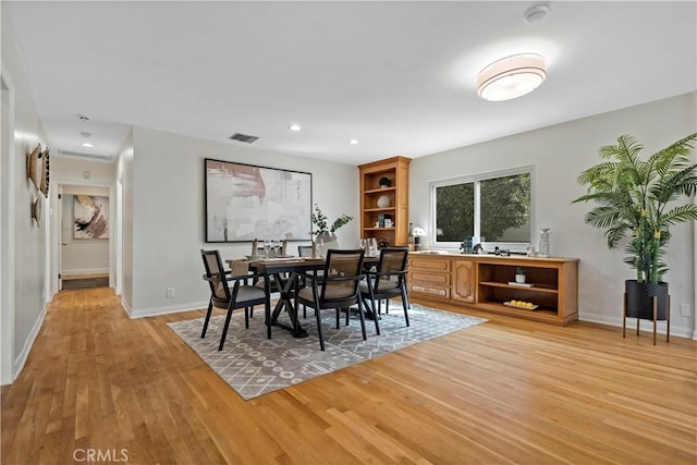 dining space with light wood-type flooring, visible vents, baseboards, and recessed lighting