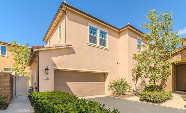 view of front of home with an attached garage and stucco siding