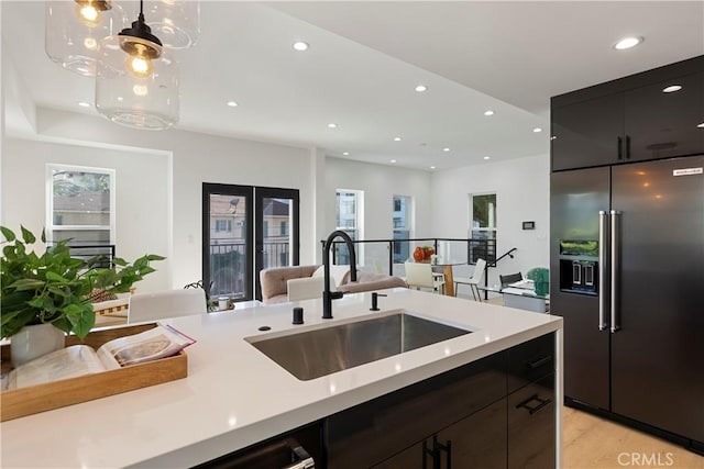 1903 N Stoke Ln, Los Angeles, CA 90068 - kitchen with high quality fridge, a sink, light countertops, open floor plan, and recessed lighting