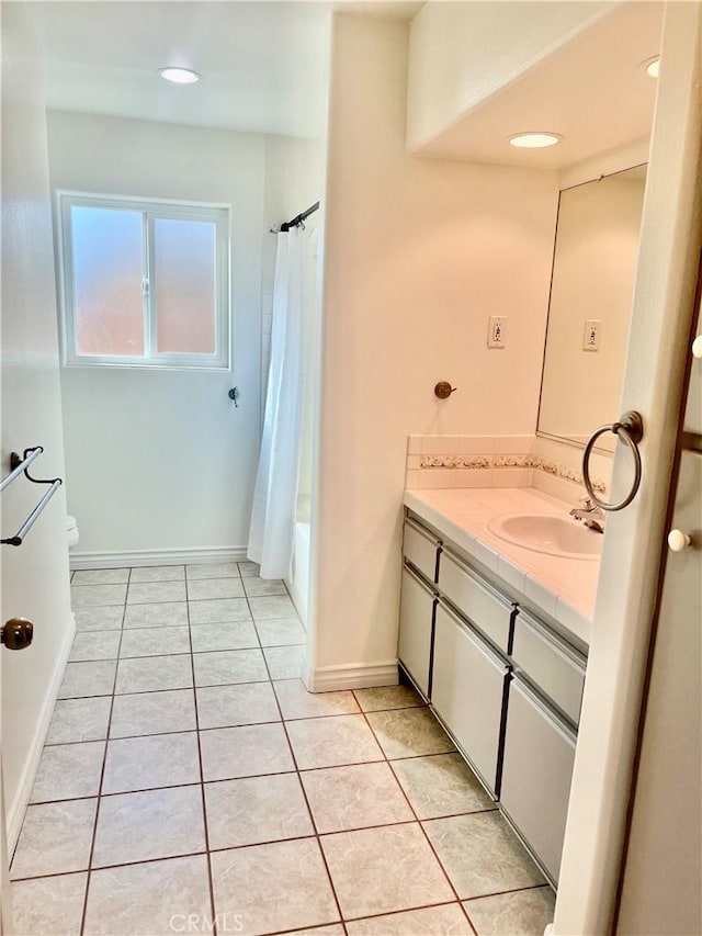 full bath featuring baseboards, toilet, shower / tub combo with curtain, tile patterned floors, and vanity