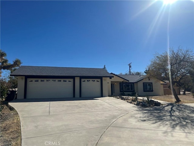 ranch-style home featuring a garage, driveway, and stucco siding