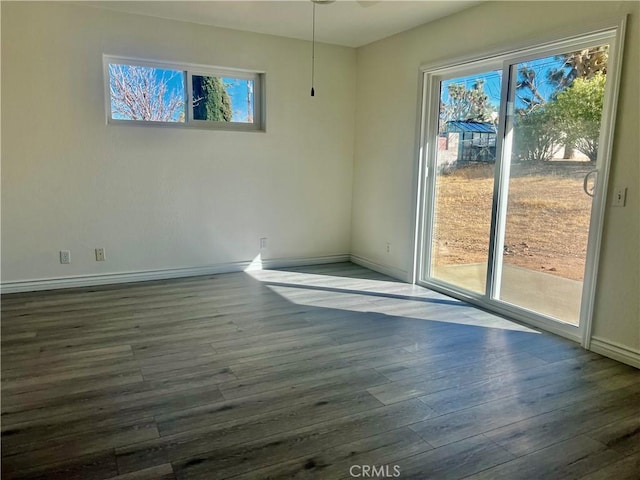 unfurnished dining area featuring wood finished floors and baseboards