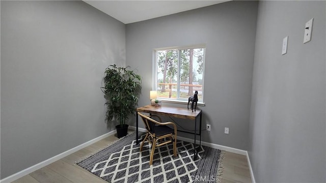 office area featuring baseboards and wood finished floors