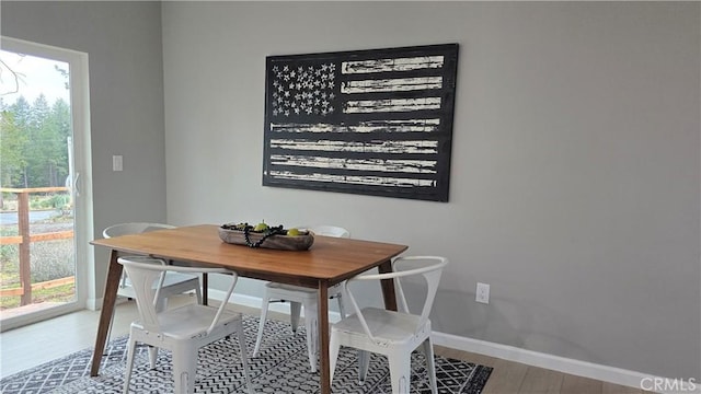 dining room featuring baseboards and wood finished floors