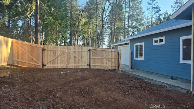 view of yard featuring fence and a gate