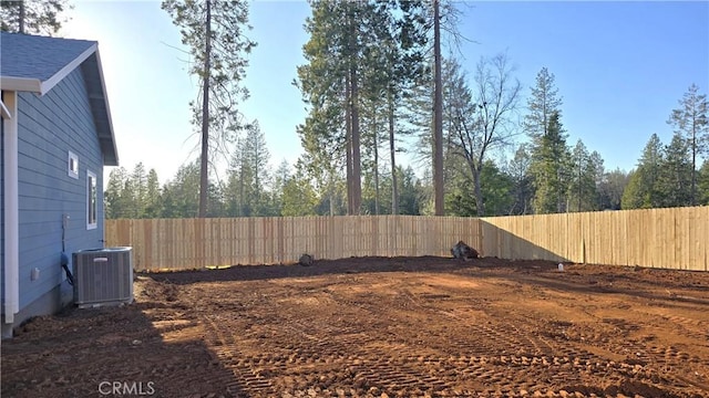 view of yard featuring a fenced backyard and central air condition unit