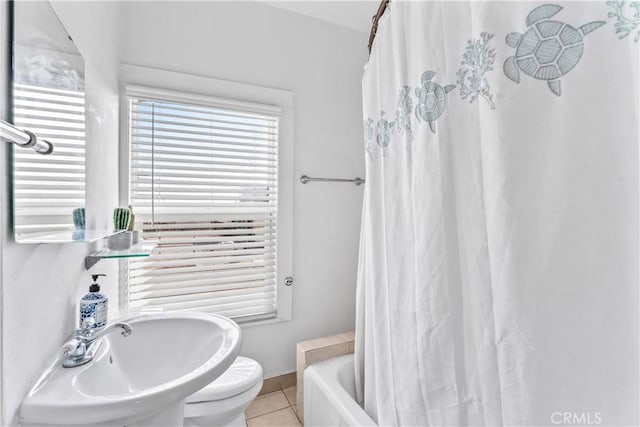 bathroom with toilet, a sink, tile patterned floors, a shower with curtain, and a bathtub