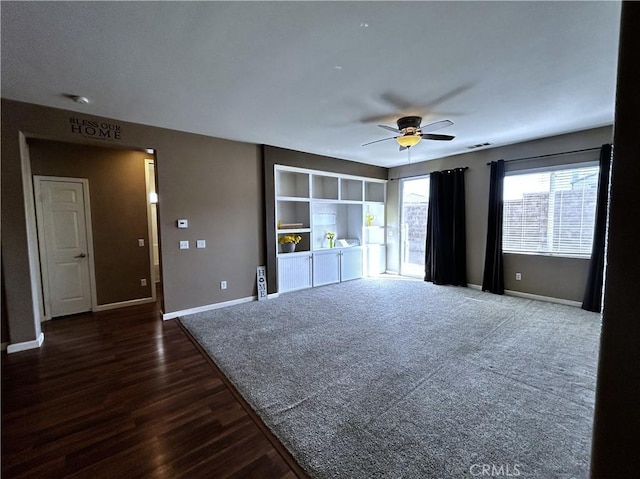 unfurnished living room with baseboards, visible vents, dark wood finished floors, and a ceiling fan