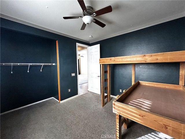 unfurnished bedroom with ceiling fan, carpet, and baseboards