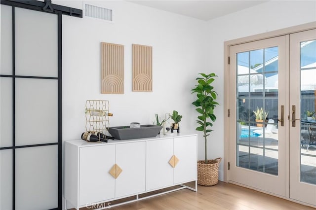 entryway featuring visible vents, light wood-style flooring, and french doors