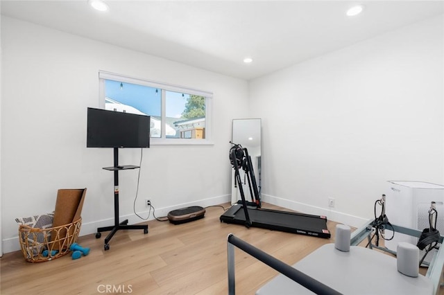 workout area with baseboards, recessed lighting, and wood finished floors