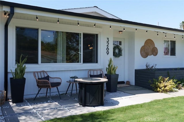 exterior space featuring a patio and an outdoor fire pit