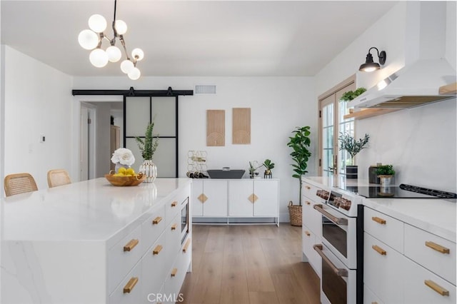 kitchen with visible vents, white electric range oven, light countertops, and range hood