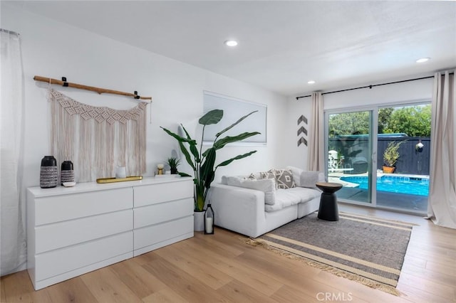 sitting room with light wood-type flooring and recessed lighting