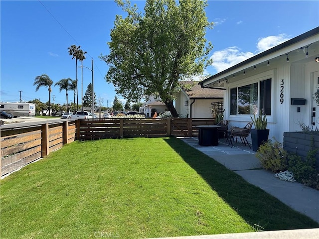 view of yard with a fenced backyard and a patio area