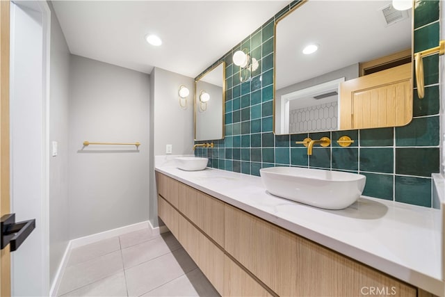 full bath with visible vents, backsplash, a sink, and tile patterned floors